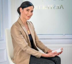Emma J holding professional skincare at Emma J aesthetics in Inverness